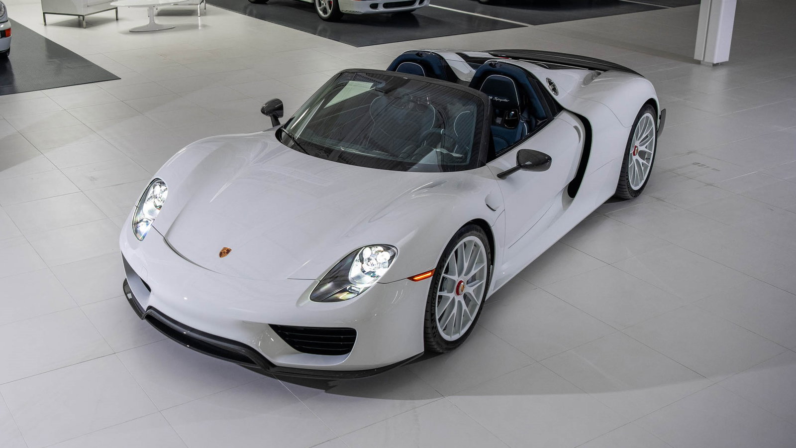 This 918 Spyder has a Yachting Blue interior, a matching luggage set, and an estimate almost triple its original list price.