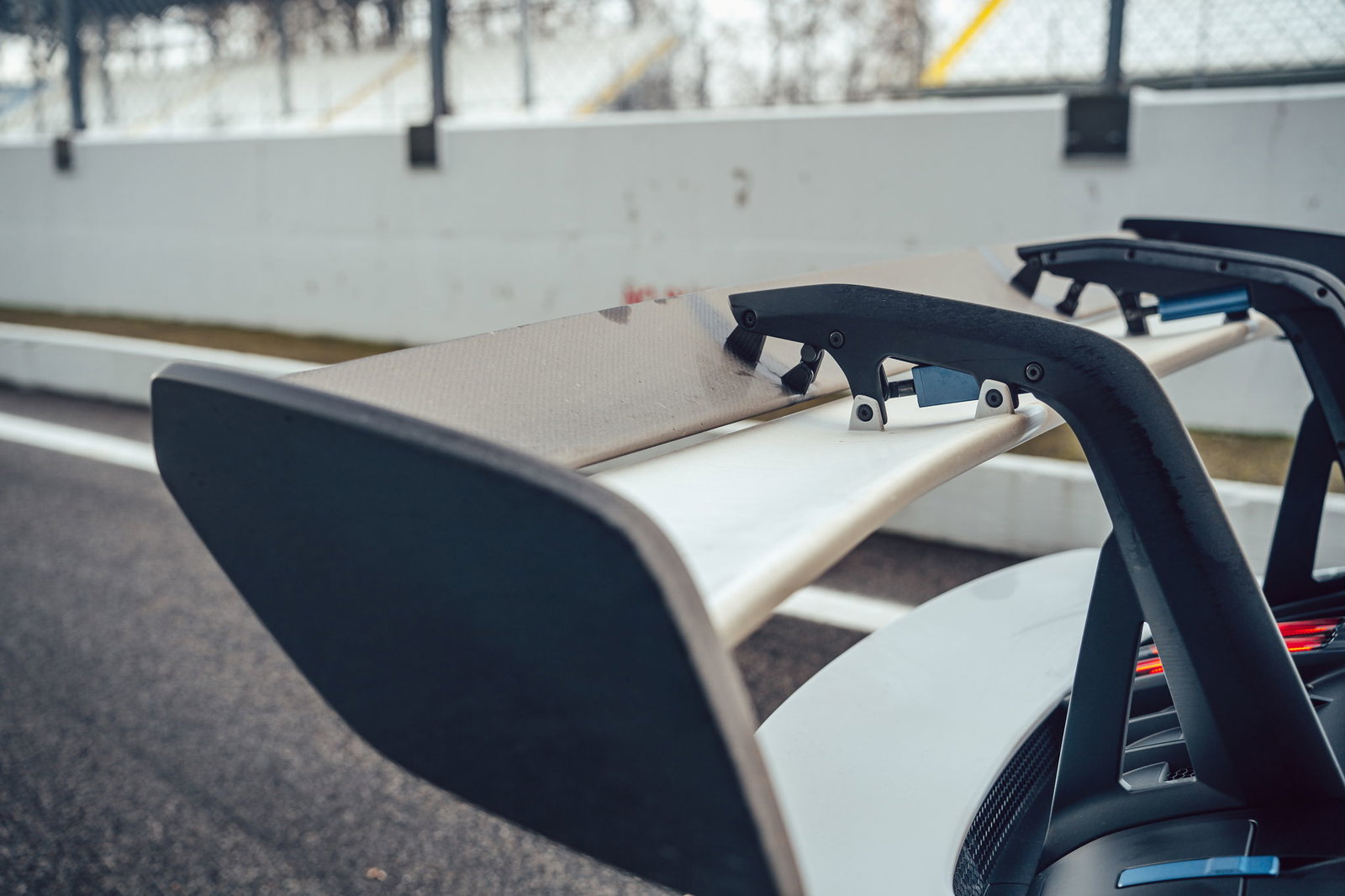 A Porsche 911 GT3's enormous rear wing in Monza's pitlane