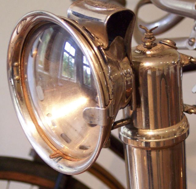 A carbide/acetylene lamp fitted to a bicycle. Via Wikimedia Commons.